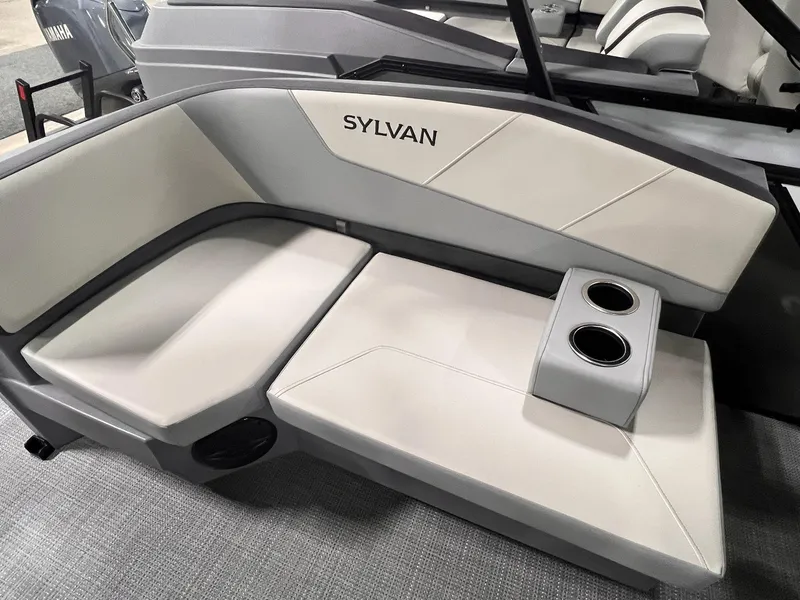 Slide: The Image of 2025 Sylvan A-Series A20 LZ DH boat interior with cushioned seating and cup holders. - 22