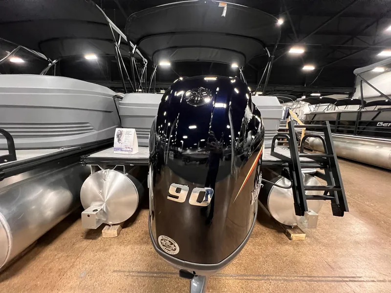 Slide: The Image of 2025 Sylvan A-Series A20 LZ DH pontoon boat with 90 HP engine displayed indoors. - 9