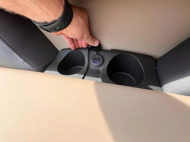 Slide: The Image of Hand adjusting USB port in 2025 Sylvan L3 CLZ DH WT cup holder area. - 12