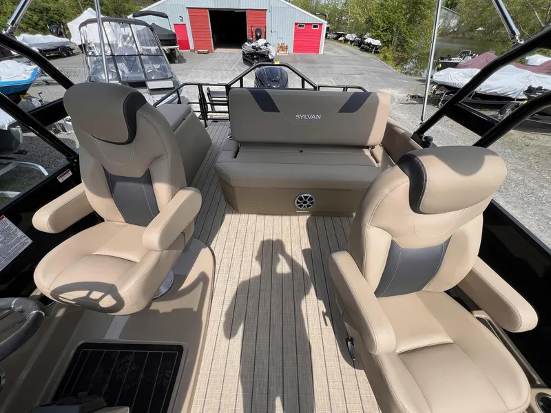 Slide: The Image of 2025 Sylvan L3 CLZ DH WT boat interior with beige seating and modern design. - 21
