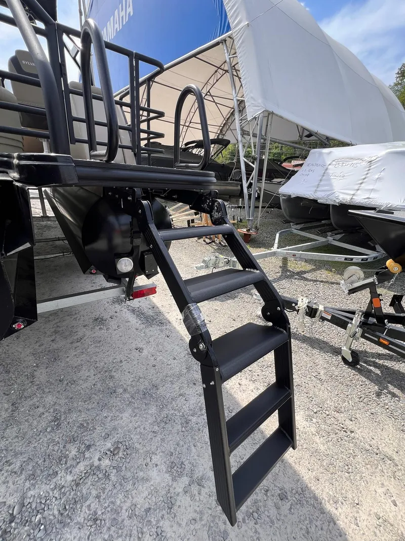 Slide: The Image of 2025 Sylvan L3 CLZ DH WT boat with foldable ladder, displayed outdoors. - 23