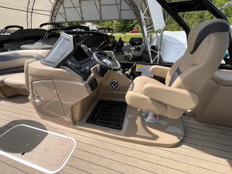 Slide: The Image of 2025 Sylvan L3 CLZ DH WT boat interior with steering console and captain's chair. - 24