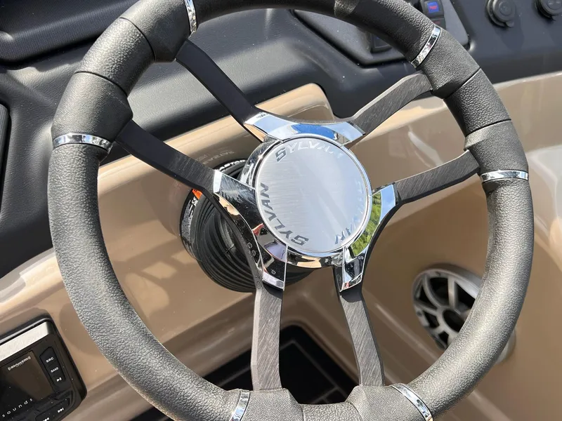 Slide: The Image of Steering wheel of 2025 Sylvan L3 CLZ DH WT boat, featuring sleek design and chrome accents. - 26