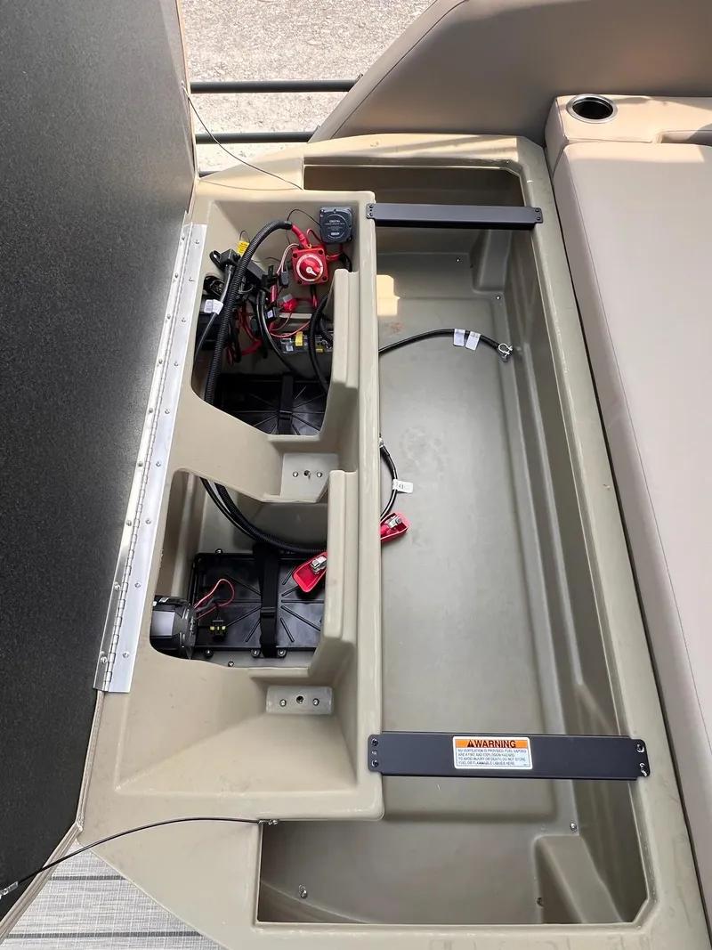 Slide: The Image of Open storage compartment in 2025 Sylvan L3 CLZ DH WT boat, showing wiring and battery setup. - 28