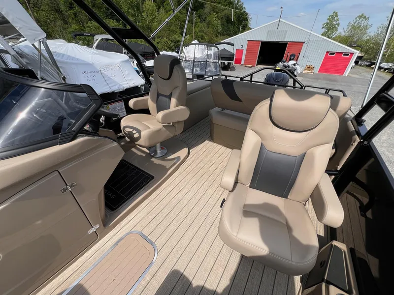 Slide: The Image of 2025 Sylvan L3 CLZ DH WT boat interior with beige seating and modern design. - 35