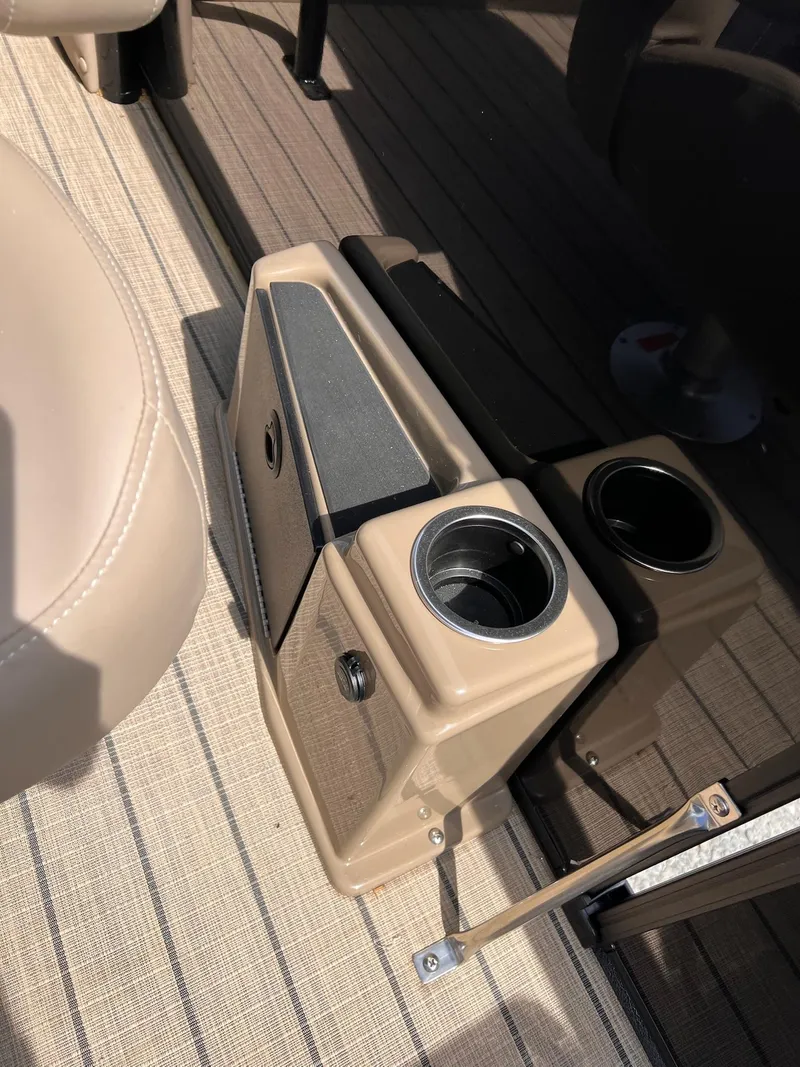 Slide: The Image of 2025 Sylvan L3 CLZ DH WT boat interior with cup holders and beige seating. - 36