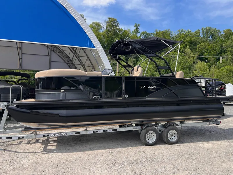 Slide: The Image of 2025 Sylvan L3 CLZ DH WT pontoon boat on trailer, parked outdoors. - 38