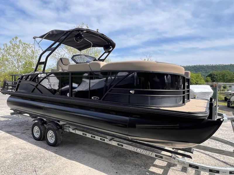 Slide: The Image of 2025 Sylvan L3 CLZ DH WT pontoon boat on trailer, sleek black design, outdoor setting. - 41