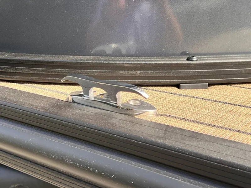 Slide: The Image of Close-up of a 2025 Sylvan L3 CLZ DH WT boat cleat on deck. - 42