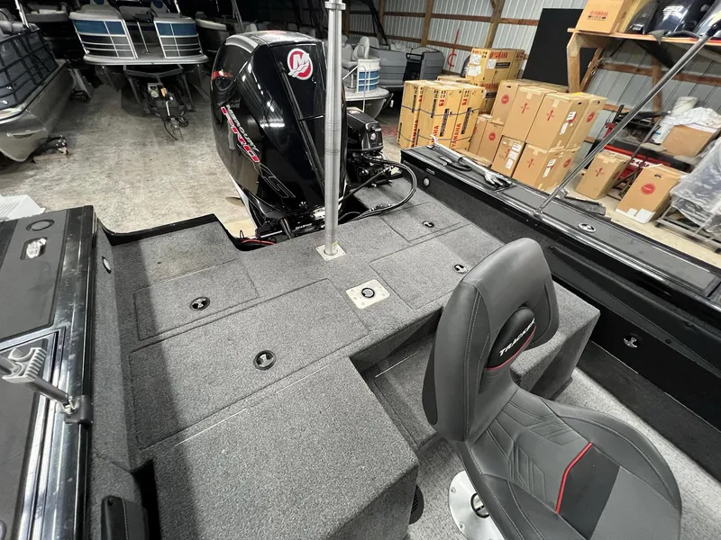 Slide: The Image of 2023 Tracker TARGA V-19 WT TE boat interior with motor and seating. - 12