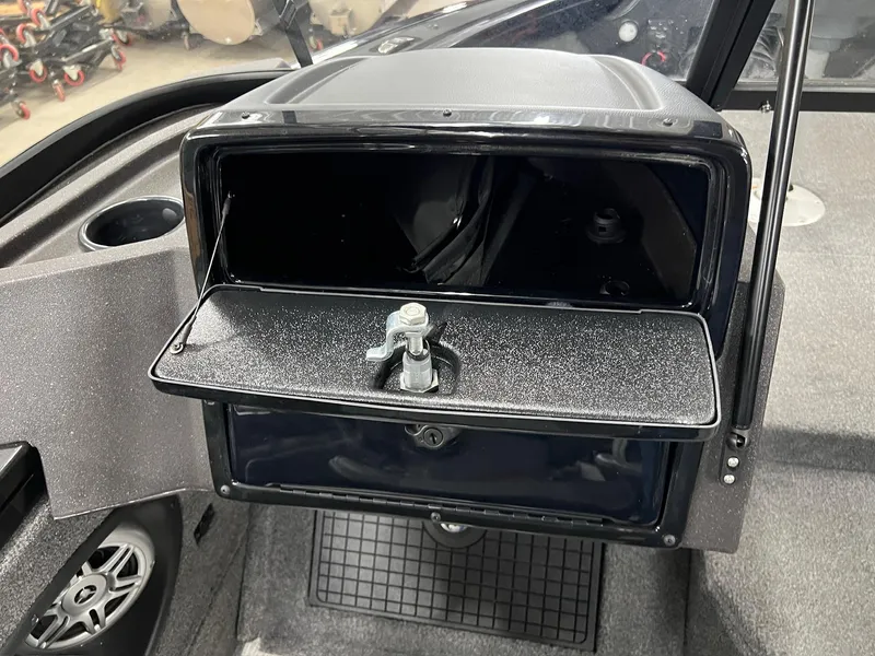Slide: The Image of 2023 Tracker TARGA V-19 WT TE boat dashboard with open storage compartment. - 14
