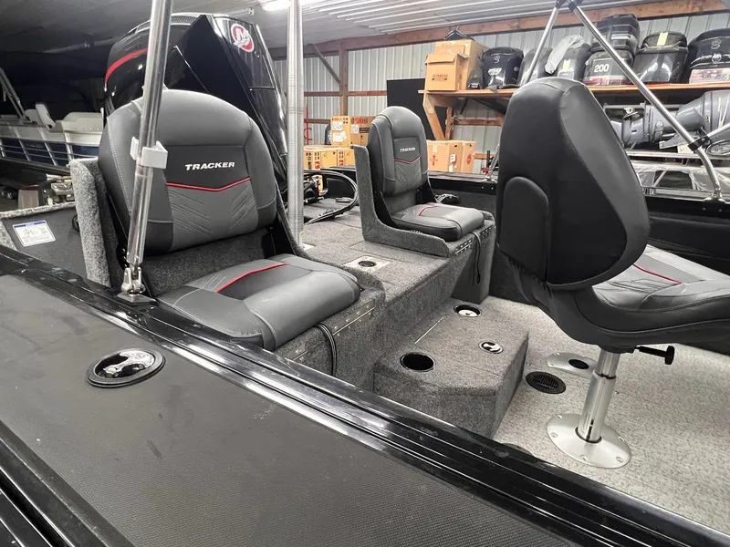 Slide: The Image of 2023 Tracker TARGA V-19 WT TE boat interior with cushioned seats and storage compartments. - 20
