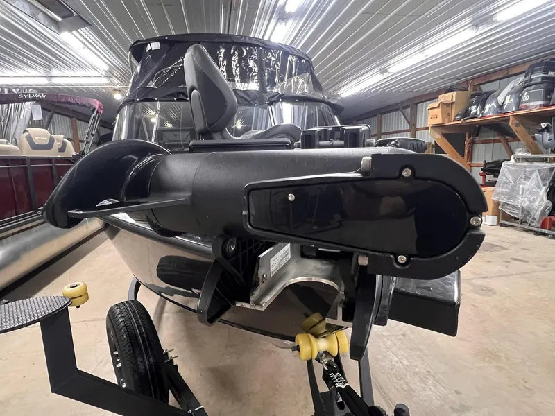 Slide: The Image of 2023 Tracker TARGA V-19 WT TE boat in a storage facility, close-up of motor. - 23