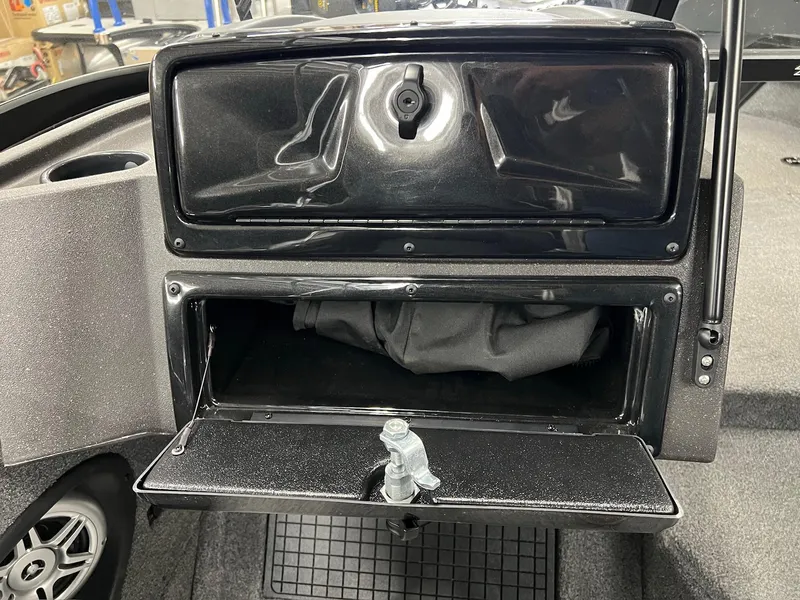 Slide: The Image of 2023 Tracker TARGA V-19 WT TE boat storage compartment with open hatch and interior view. - 26