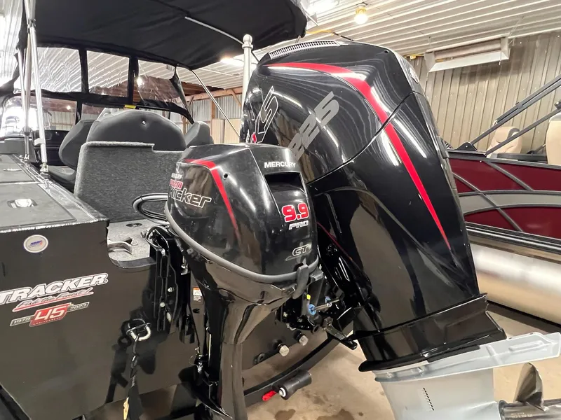 Slide: The Image of 2023 Tracker TARGA V-19 WT TE boat with dual Mercury outboard motors in a showroom. - 28