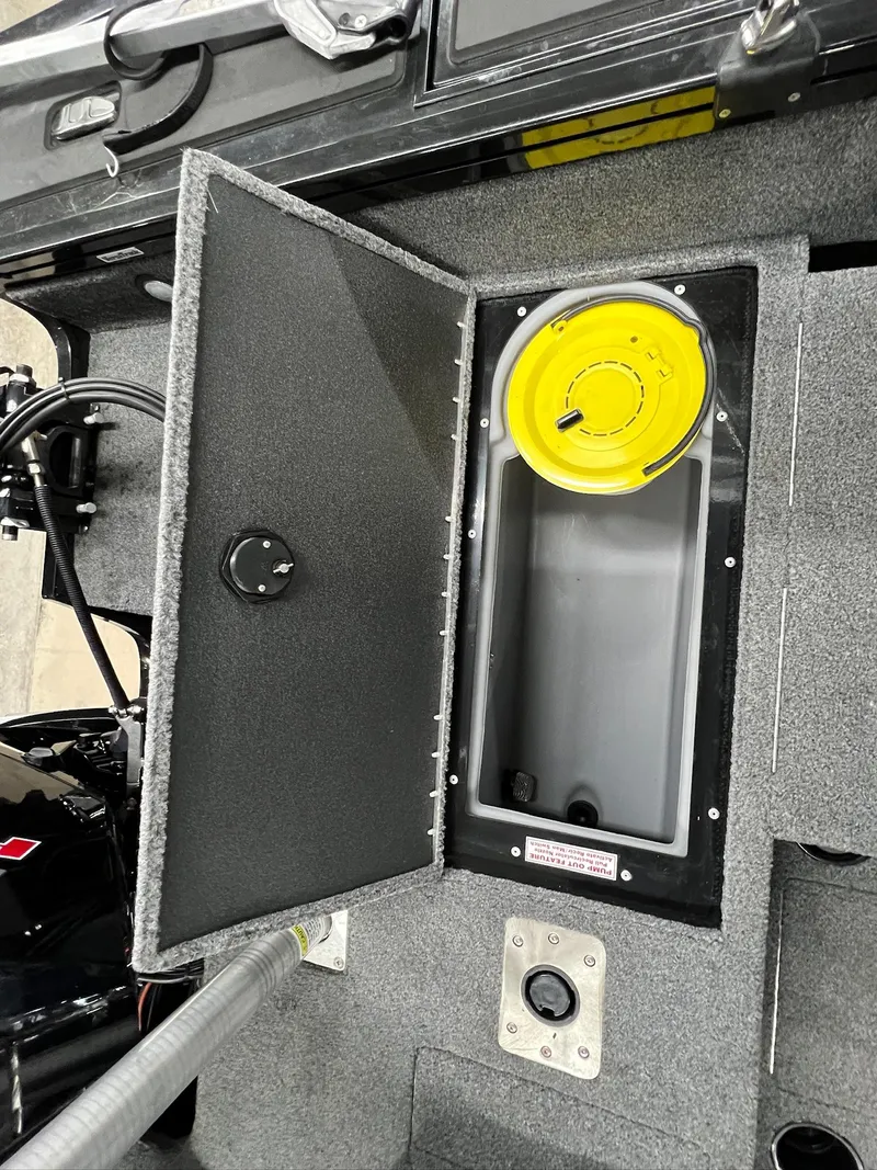 Slide: The Image of 2023 Tracker TARGA V-19 WT TE boat storage compartment with open lid and yellow container. - 29