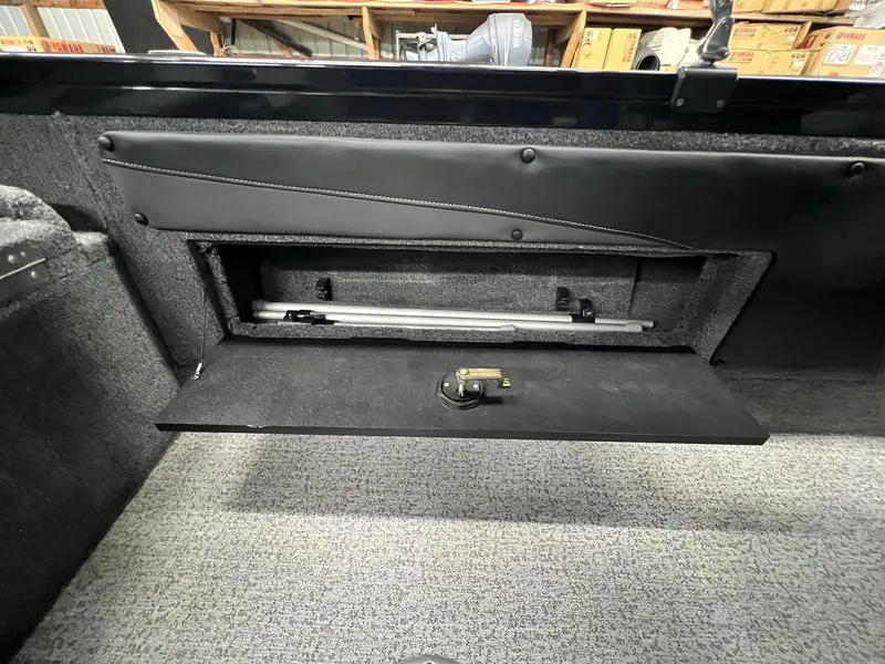 Slide: The Image of 2023 Tracker TARGA V-19 WT TE storage compartment with open hatch and visible interior. - 3