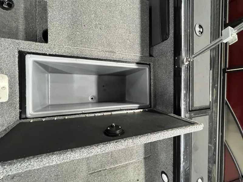 Slide: The Image of 2023 Tracker TARGA V-19 WT TE boat storage compartment, open and empty. - 32