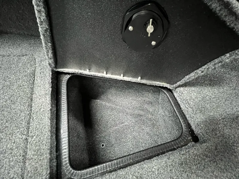 Slide: The Image of 2023 Tracker TARGA V-19 WT TE boat storage compartment with carpeted interior. - 33