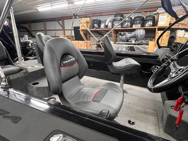 Slide: The Image of 2023 Tracker TARGA V-19 WT TE boat interior with gray seats and steering wheel. - 34