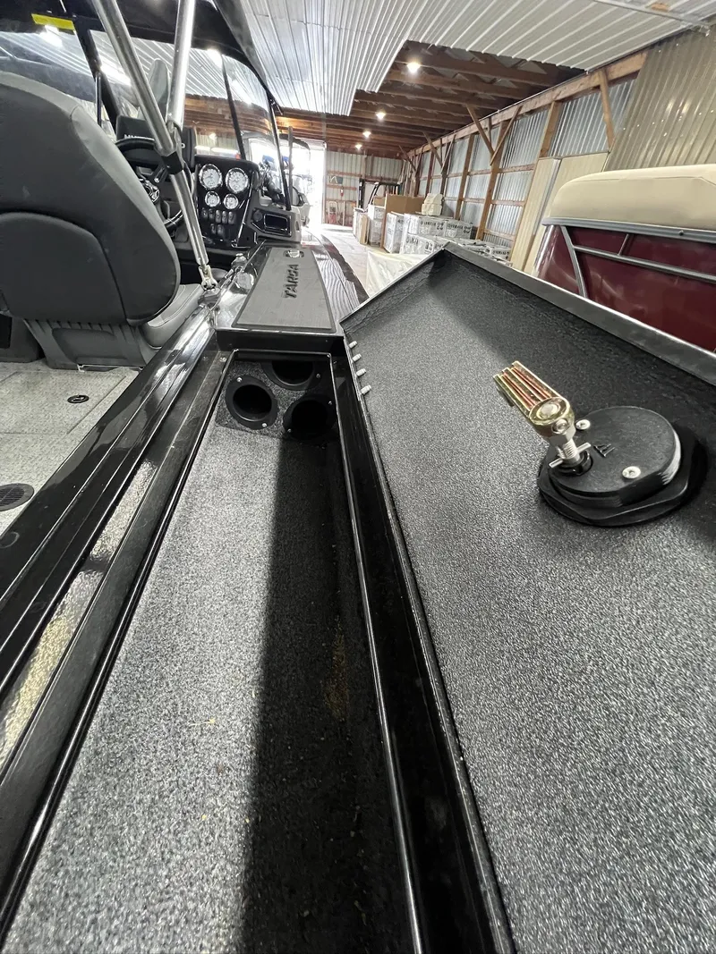 Slide: The Image of 2023 Tracker TARGA V-19 WT TE boat interior with storage compartment and control panel. - 36