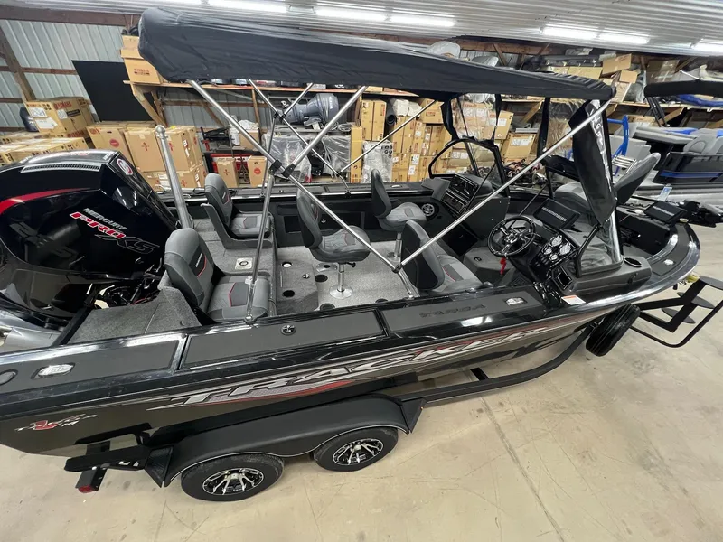 Slide: The Image of 2023 Tracker TARGA V-19 WT TE boat with canopy in a warehouse setting. - 44