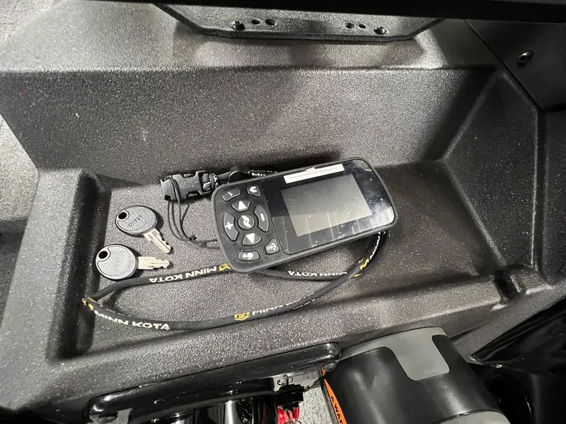 Slide: The Image of 2023 Tracker TARGA V-19 WT TE dashboard with keys and electronic device. - 46