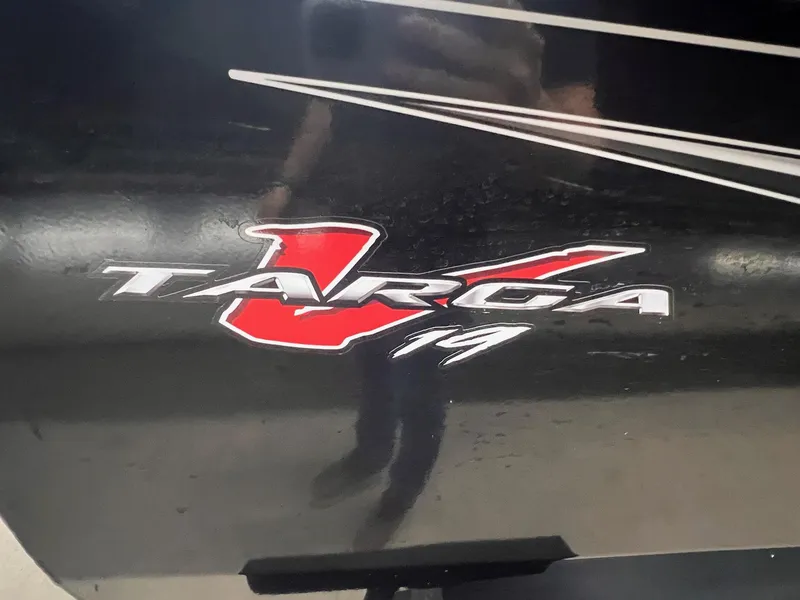 Slide: The Image of 2023 Tracker TARGA V-19 WT TE logo on a black surface. - 48