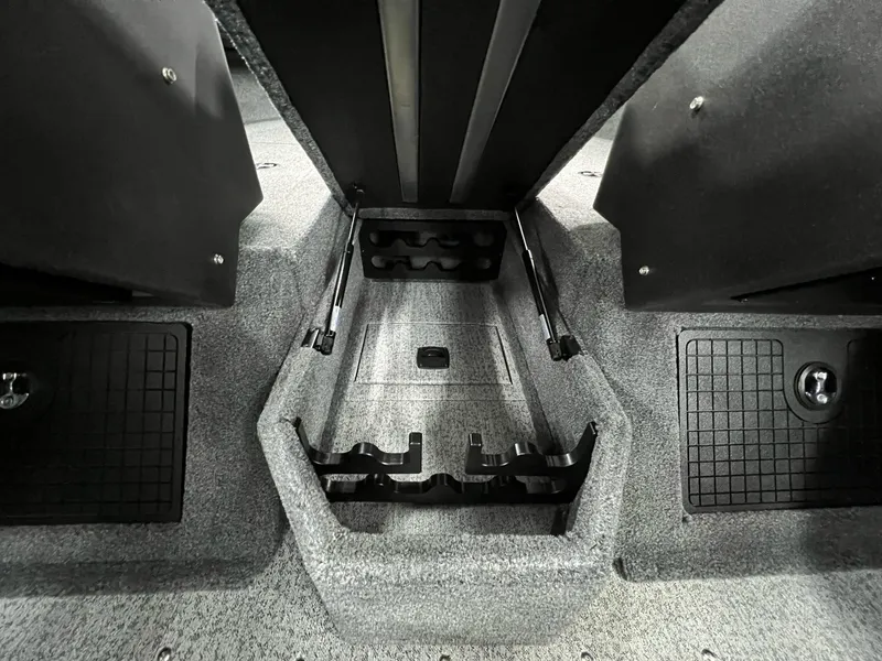 Slide: The Image of 2023 Tracker TARGA V-19 WT TE interior storage compartment with carpeted finish and secure holders. - 6