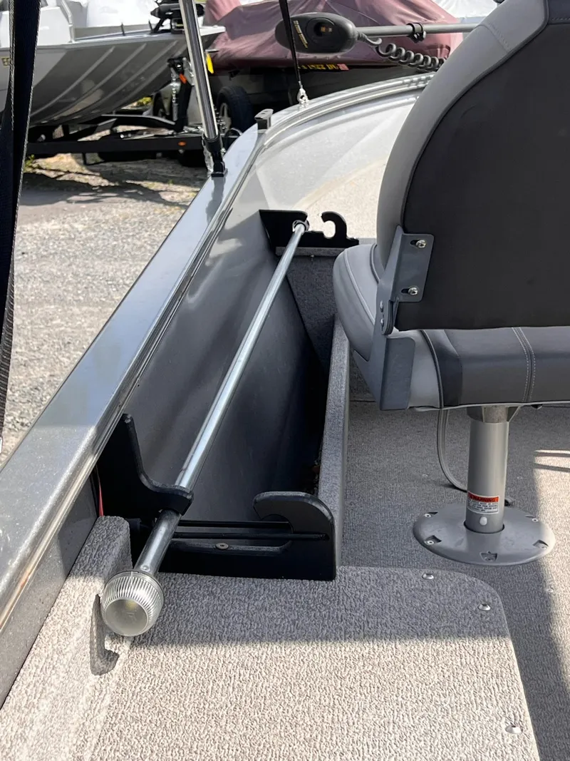 Slide: The Image of 2016 Crestliner 1650 Discovery Side Console interior with seating and storage. - 11