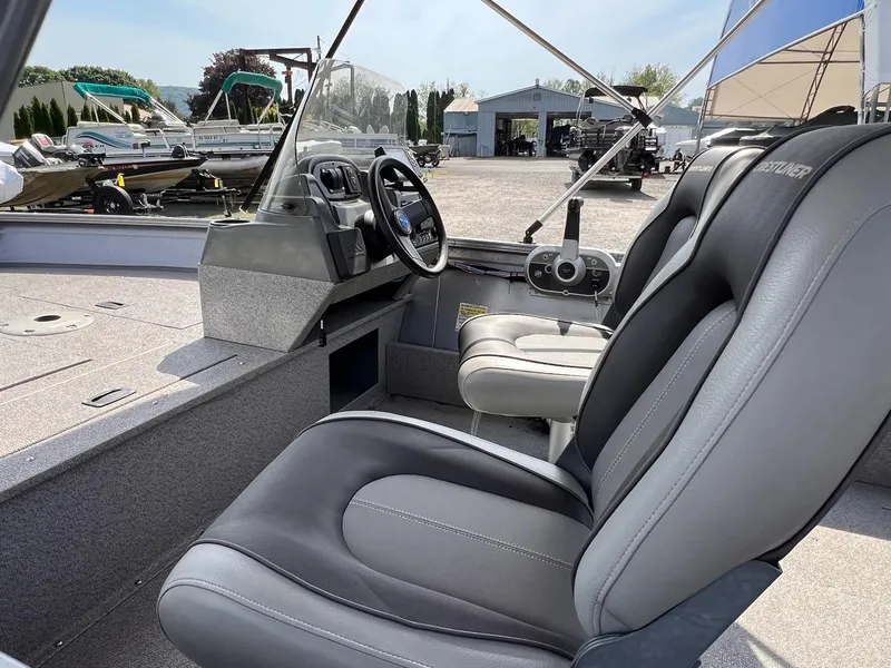 Slide: The Image of 2016 Crestliner 1650 Discovery Side Console boat interior with steering wheel and seating. - 12