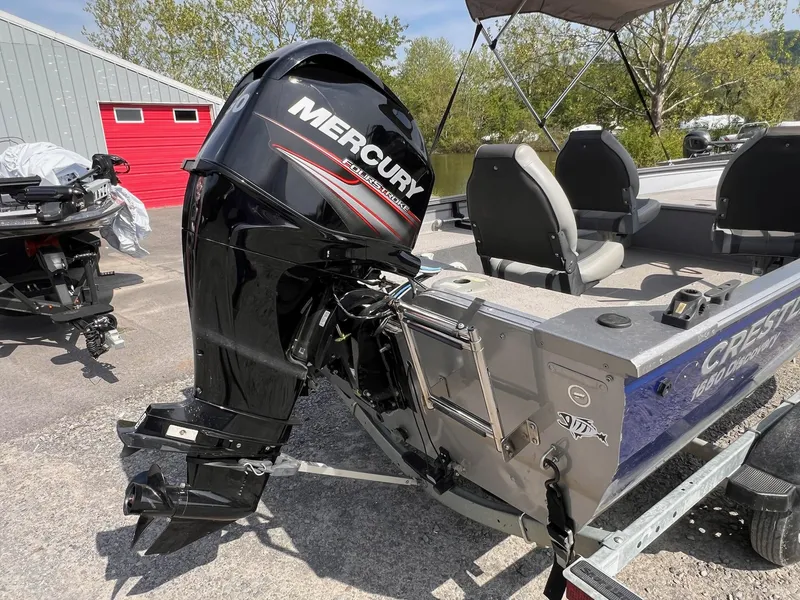 Slide: The Image of 2016 Crestliner 1650 Discovery Side Console boat with Mercury outboard motor, parked outdoors. - 13