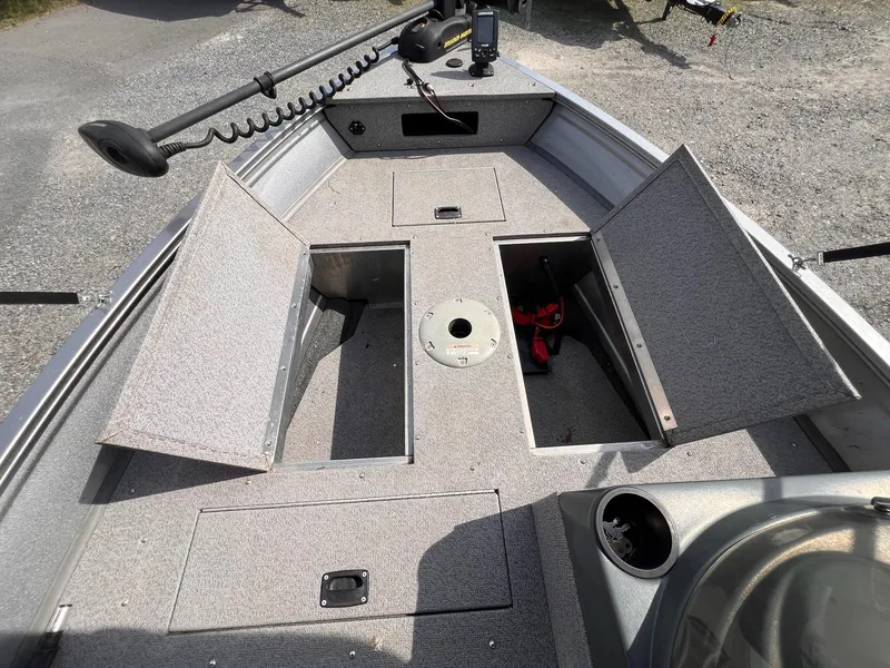 Slide: The Image of 2016 Crestliner 1650 Discovery Side Console boat interior with open storage compartments. - 16