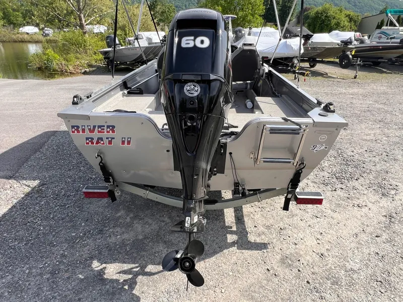 Slide: The Image of 2016 Crestliner 1650 Discovery Side Console boat with 60 HP motor, parked outdoors. - 17