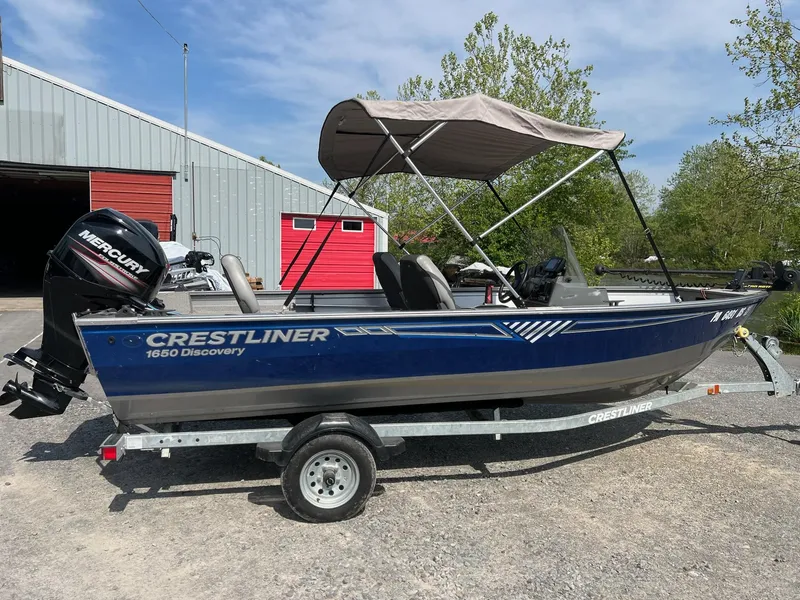 Slide: The Image of 2016 Crestliner 1650 Discovery Side Console boat on trailer, with Mercury outboard motor. - 20