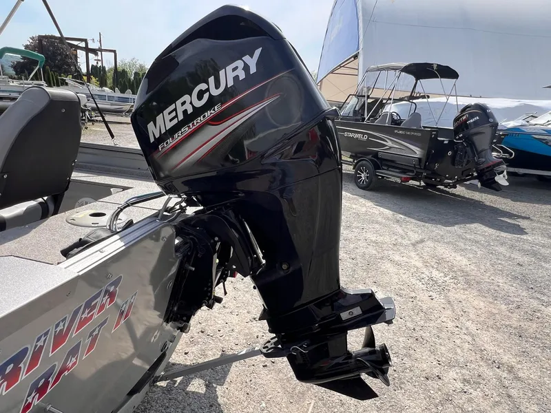Slide: The Image of 2016 Crestliner 1650 Discovery with Mercury FourStroke engine, parked on gravel lot. - 21