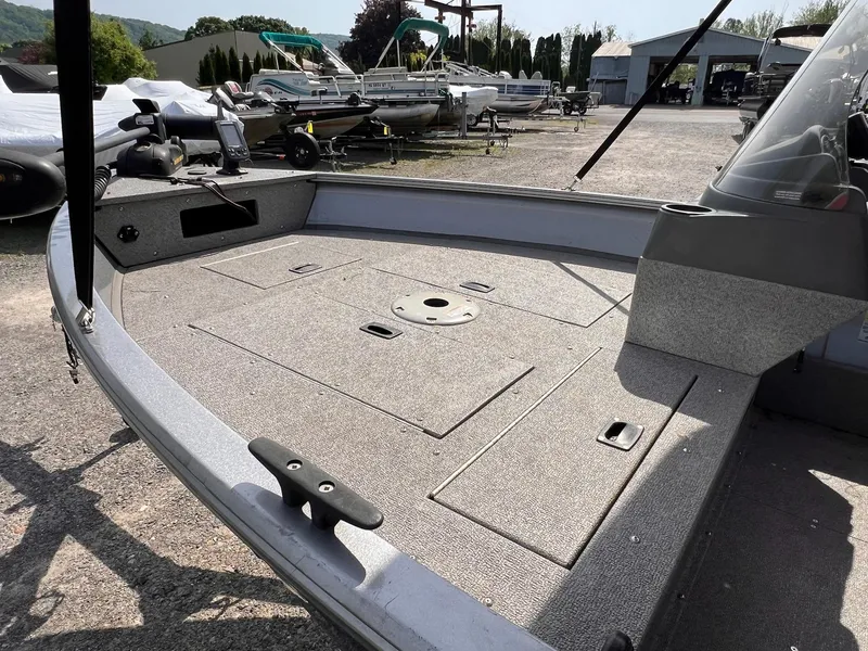 Slide: The Image of 2016 Crestliner 1650 Discovery Side Console boat, spacious deck, parked outdoors. - 23