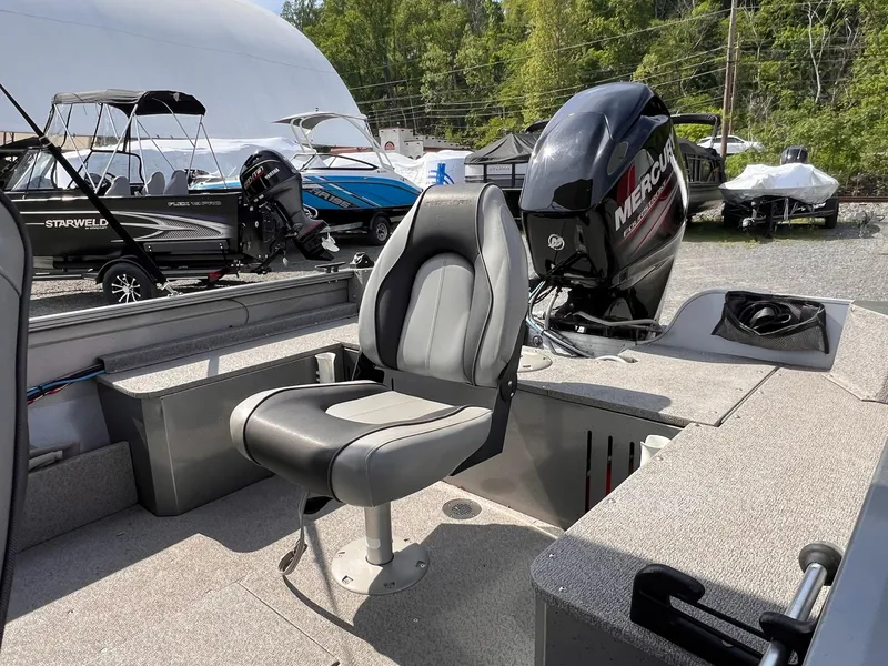 Slide: The Image of 2016 Crestliner 1650 Discovery Side Console boat with Mercury outboard motor and seating. - 25