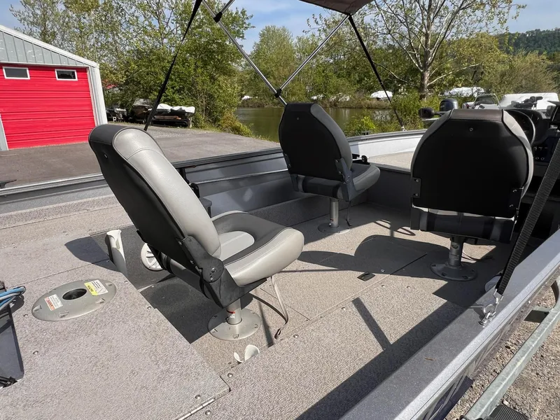 Slide: The Image of 2016 Crestliner 1650 Discovery Side Console boat interior with two swivel seats. - 28