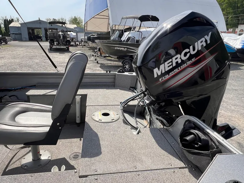 Slide: The Image of 2016 Crestliner 1650 Discovery Side Console with Mercury FourStroke engine, parked outdoors. - 3