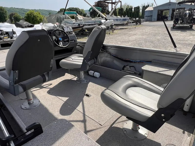 Slide: The Image of 2016 Crestliner 1650 Discovery Side Console boat interior with seating and console. - 31