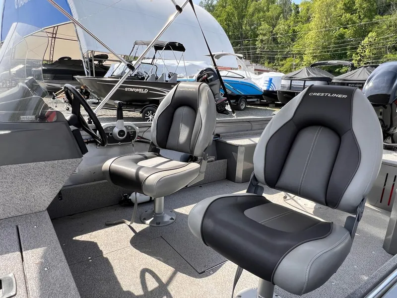 Slide: The Image of 2016 Crestliner 1650 Discovery Side Console boat interior with two seats and steering console. - 4