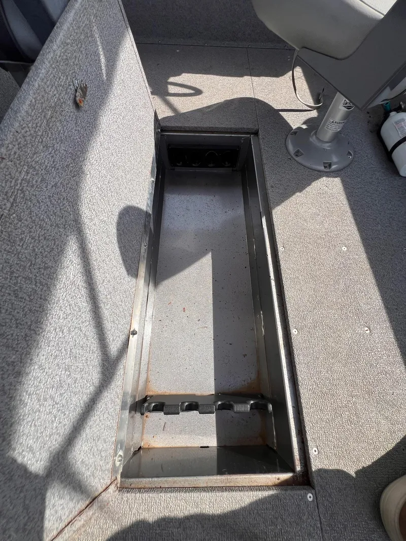 Slide: The Image of 2016 Crestliner 1650 Discovery Side Console boat storage compartment, open and empty. - 9