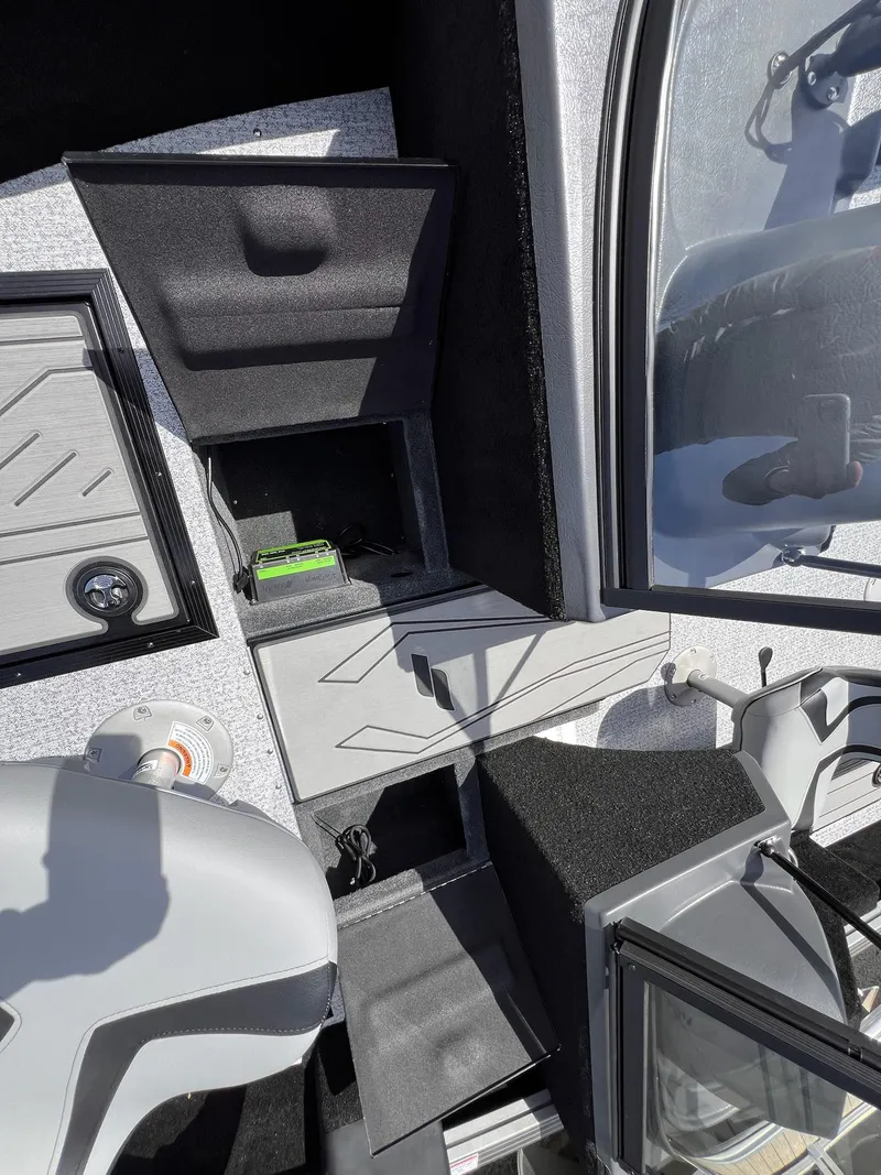 Slide: The Image of Interior of 2025 Starcraft Storm 176 DC Pro SE boat, featuring storage compartments and seating. - 12