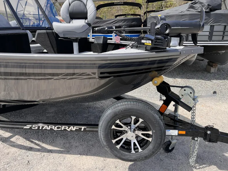 Slide: The Image of 2025 Starcraft Storm 176 DC Pro SE boat on trailer, featuring Minn Kota motor. - 14