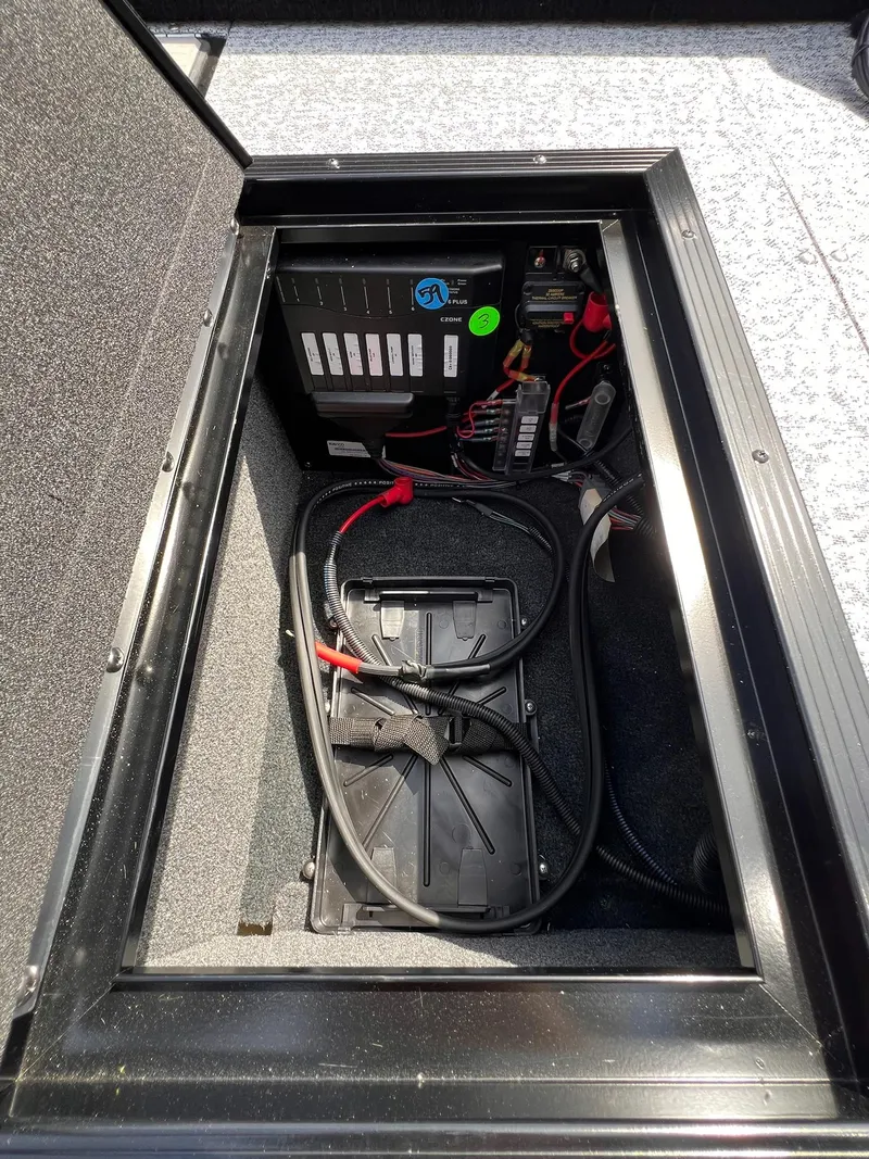 Slide: The Image of Battery compartment of 2025 Starcraft Storm 176 DC Pro SE boat, featuring wiring and components. - 17
