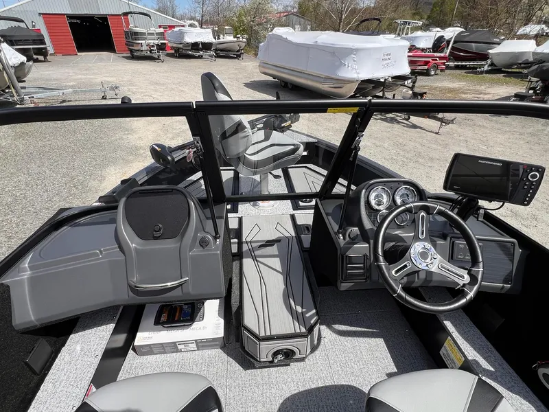 Slide: The Image of 2025 Starcraft Storm 176 DC Pro SE boat interior with steering wheel and dashboard controls. - 18
