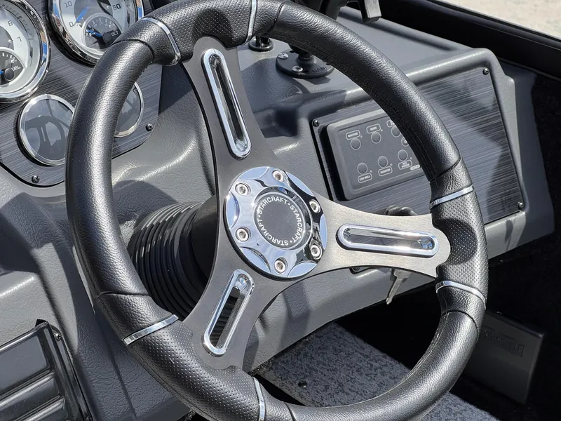 Slide: The Image of Steering wheel of 2025 Starcraft Storm 176 DC Pro SE boat, featuring modern dashboard controls. - 19