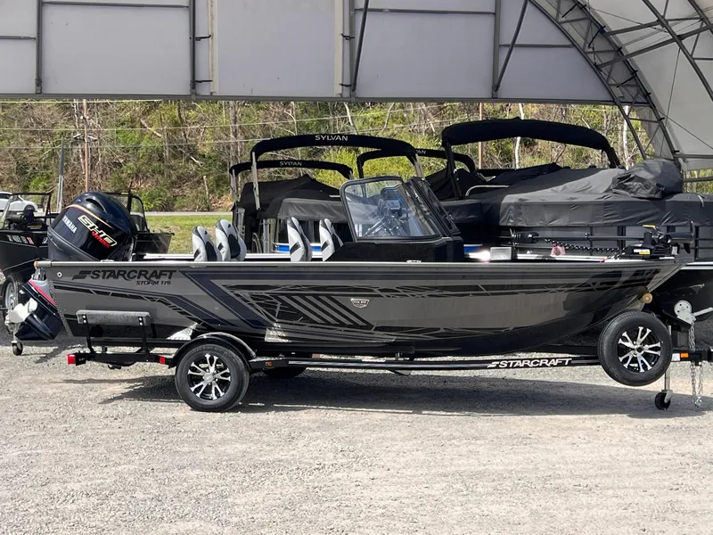 Slide: The Image of 2025 Starcraft Storm 176 DC Pro SE boat on trailer, parked outdoors. - 20