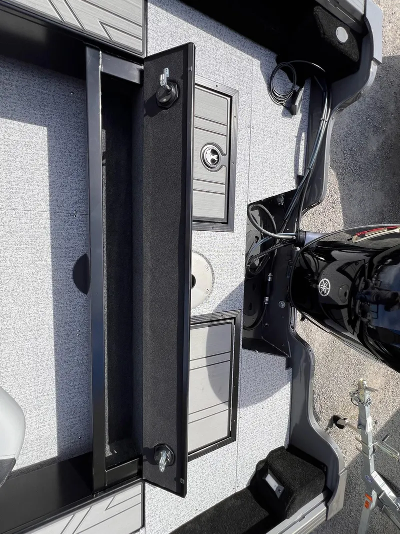 Slide: The Image of 2025 Starcraft Storm 176 DC Pro SE boat interior with open storage compartment and motor. - 22